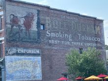 Old building with an ad extolling the joys of "Smoking Tobacco", given the large amount of cannabis shops in Washington, seems like people are still smokin"KThe