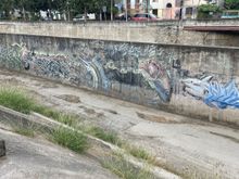 Up river along the canal.  The canal is usually pretty empty except during the rainy season, so some artists has headed to divided wall in the canal to express his or her's inner Diego