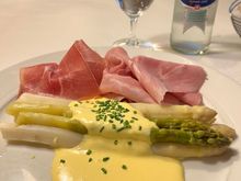 while asparagus with hollandaise sauce and ham