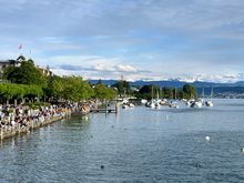 Beautiful Day in Zurich - you can see the snow-capped mountains in the distance. Waterfront is filled with locals