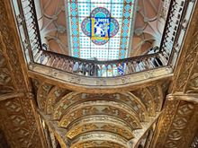 Looking up at the stairs and stained glass ceiling at Livraria Lello