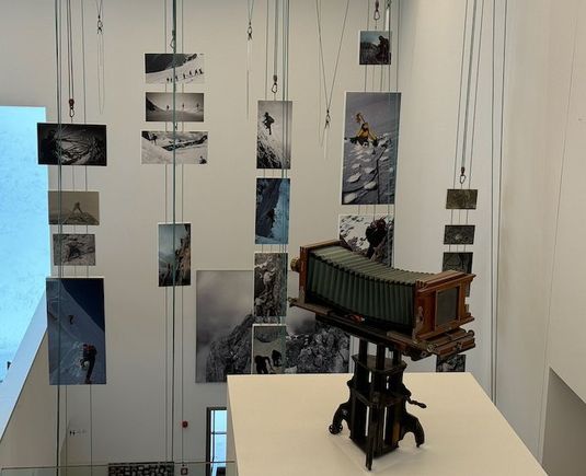 This set of photos mounted on ropes all covers images of rope-climbing teams.