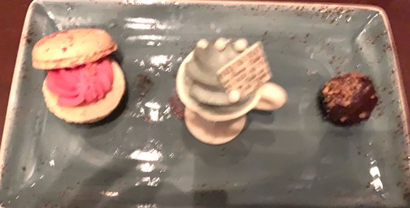 Desert trio. Raspberry macaron white chocolate cup filled with the grey stuff and a dark chocolate truffle