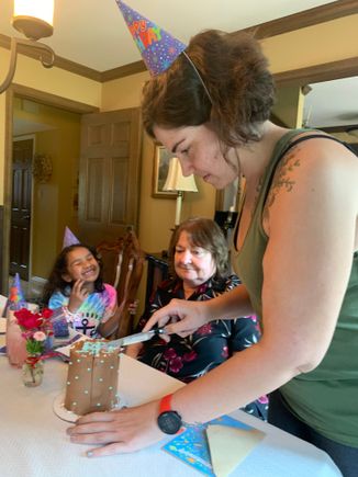 Whatever that cake was, it was delicious! From left to right, Michaela; the birthday sister; and Nicole, Nick’s sister and Michaela‘s mom.