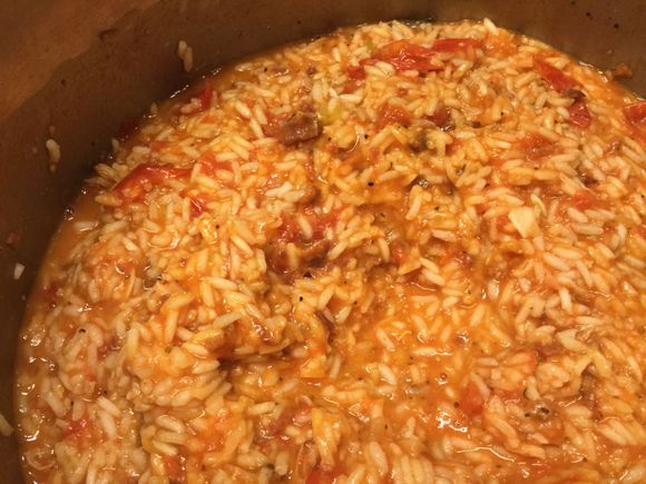 
Risotto made with tomato sauce and stock and wine, with parmesan and assorted leftover pork products added in.

