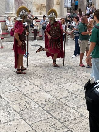 You will see a number of Roman guards around who will happily pose for pictures for a few euros.  There happened to be some young men with a soccer ball who were playing with the guards. If you look closely at the guard on the left you can see a soccer ball!