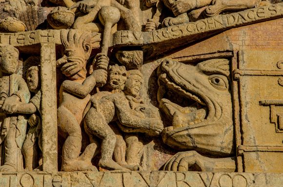 Detail from famed 12C Tympanum of the Last Judgement. This panel shows a demon forcing Trump supporters into a monster's mouth.