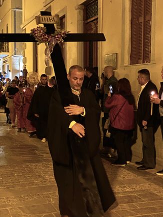 The procession moves through the street