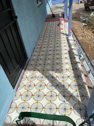 Tiles in process. The red and yellow dots are spacers.
You can see a bit of house color and a tiny bit of trim. 