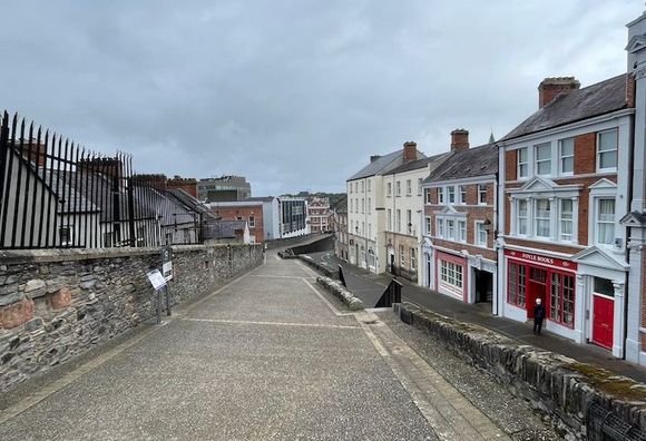 Along the wall on the west side