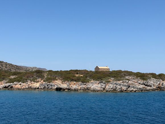 Boat docked near Spinolonga peninsula for swimming 
