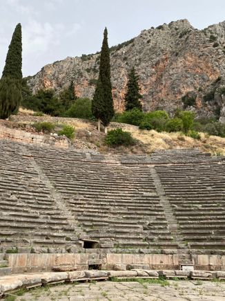 Looking up toward the ancient theatre, the largest structure of the Temple of Apollo. It housed a total of 5000 spectators. 

At the time we were there, work was being done on the steps leading up and beyond the theater. 