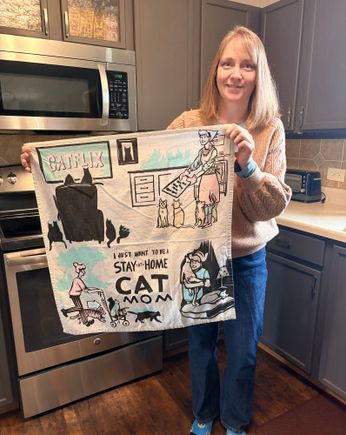 My daughter,  holding her favorite kitchen towel. 