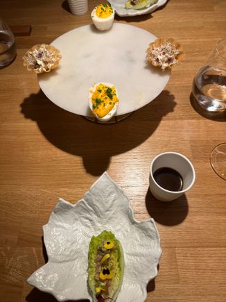 Dinner began with SIMPAR'S version of "brunch:" Waldorf salad, in foreground, in half a gem lettuce heart;  "egg Benedict--" the yolk is savory meringue and the yellow is......downright delicious!!  Tartelets of almond in a frothy consistency, and "coffee," which was an intense and lovely hot mushroom broth, which we were instructed to sip after every bite of food.