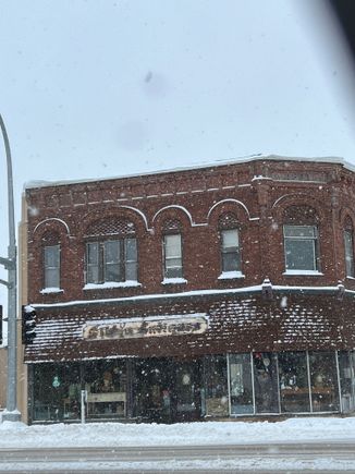 one of our towns origional stores with snow flakes coming down.