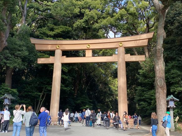 The large Torii gate, one of the two entrances to the Meiji shrine. The torii marks the divide between sacred space and the profane. 