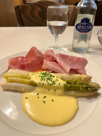 while asparagus with hollandaise sauce and ham