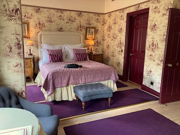 The walls are entirely padded/upholstered toile