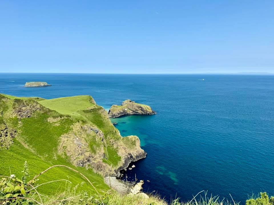 The not particularly visible Carrick-a-Rede rope bridge with spectacular surroundings