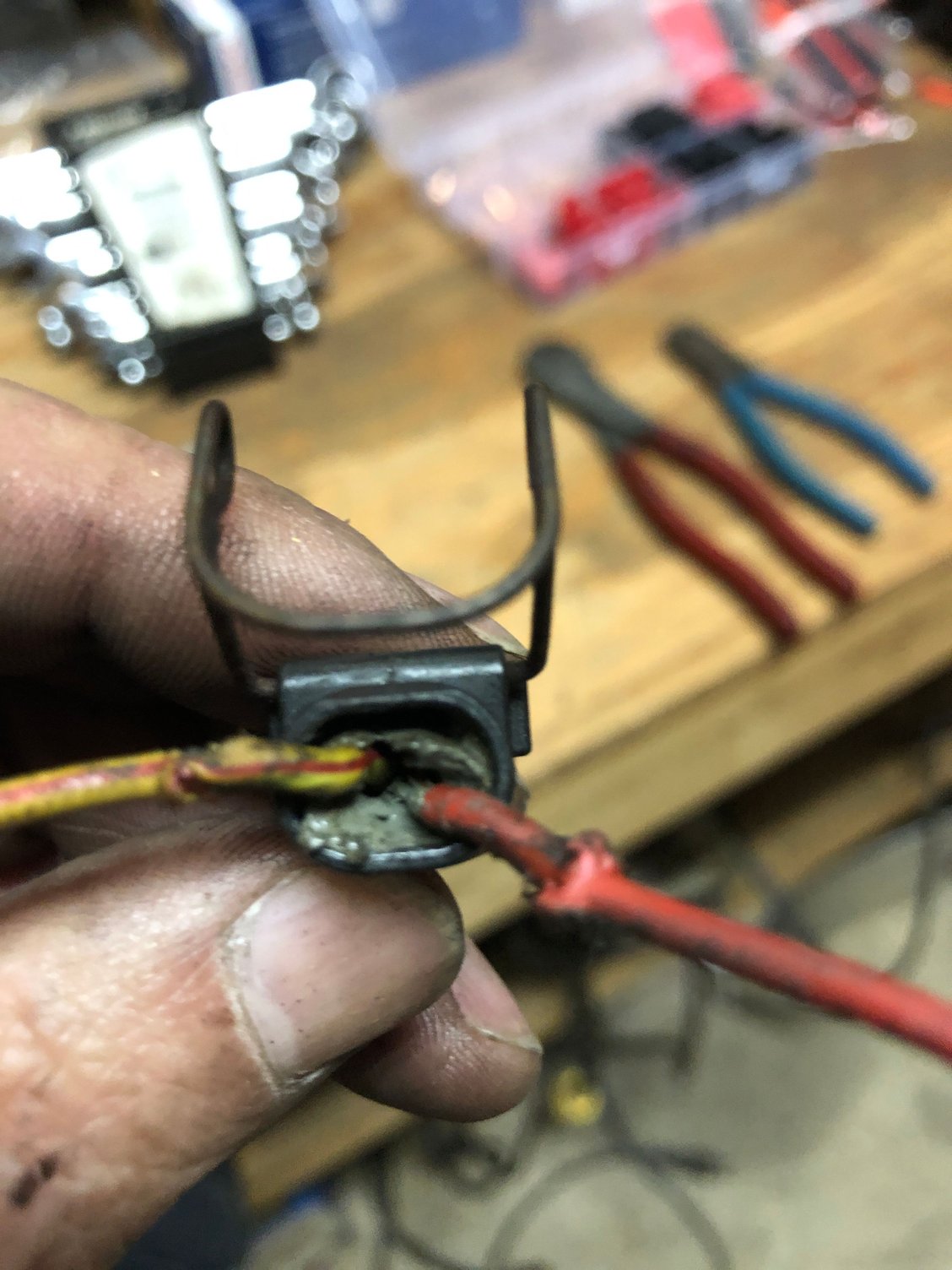 Almost like extra insulation on the red wire where they we�re fused together. Grey goo inside, I�m assuming that was an insulator material