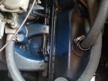 Bolt sticking out below valve cover mid way.