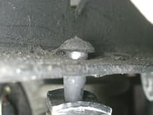 Passenger side frame pin near front of vehicle