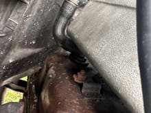This is a PCV… right? (passenger side, connects to upper intake manifold, has a small filter/valve inside.