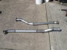 2-1/2" exhaust pipes from the headers tot he mufflers.  The local muffler guy quoted a kings ransom to make these.  The right one is a little tough because it has to stay above the torsion bar, transmission cross member, and rear torsion bar cross member before dropping down. Drivers side is more conventional.
