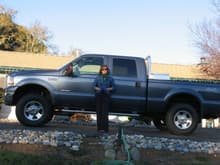 Photo from this past winter, in December the day we put the headache rack and tool box on the truck with my beautiful wife modeling the new tires as well.  :)