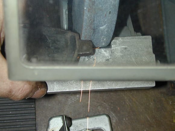 Using a bench grinder LIGHTLY to clear severe rust or correct improper clearance of aftermarket pads.