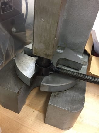 Pressing lubed rubber bushing into end link.