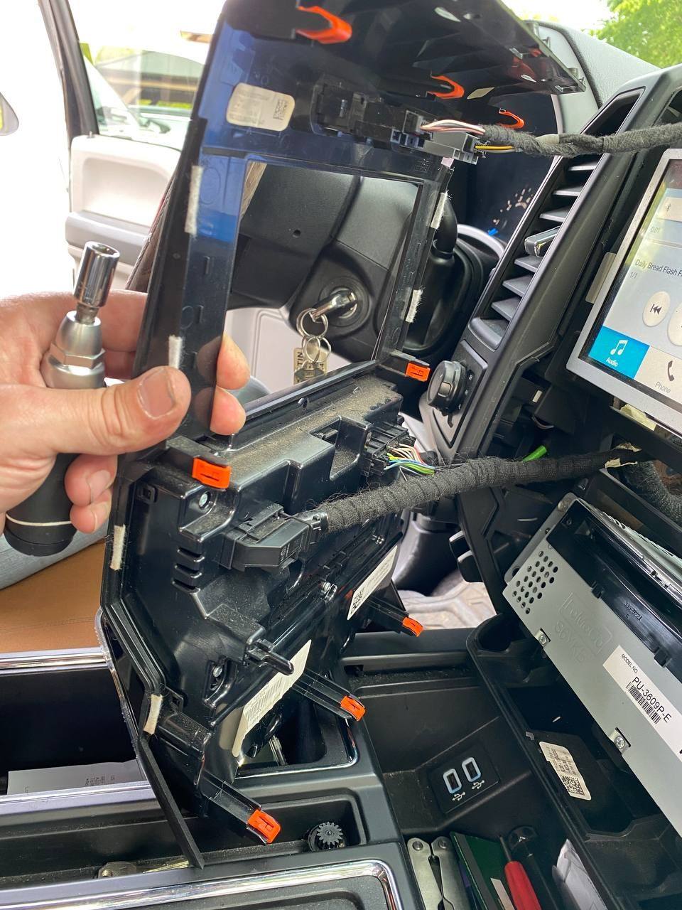 The faceplate has 8 clips, a firm tug at the top will release it. There are 2 screws on top (previous picture)