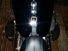 Leather belt with brass buckle tank bib. Waiting for my gloss black primary cover and frenched headlight trim ring to come back from the powder coater.