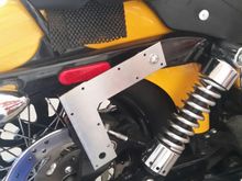 Mounted with a longer bolt and a small spacer to bring it out from the strut.