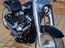 Monster Sucker on my Stage 2 114 FatBoy,runs close to my leg when riding but does not distract from riding. Im 5'10" in height.