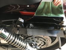 Here is the bracket mounted to the bike with the rotating latch on it in latched position.  The little button on top is the lock, just press it down to lock.