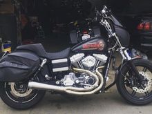 My bike. Maybe it’ll give you an idea on where you want to proceed

13.25 shocks
Nix22 fronts 
Dual disc conversion 
Twin galfer wave rotors
Speed merchant radial brackets with tokico rotors
Bassani rr3 
Brembo rcs19 11/16 master 
Big als 8” pullbacks with 3.5 inch bars
Saddlemen stepup seat 
Leatherpros all leather bags 