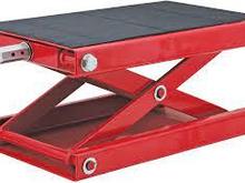 This is the type of scissor jack I was referring to. It's made specifically for bikes . Easy to use to do what you need and it's only about $80.