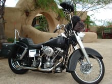 L1970 FX 1200cc Shovelhead with first cone head ignition. Built with all used parts. 1948 Duo Glide ft end, 1948 4 speed kicker only tranny, early 1 1/2" belt open primary with Primo racing clutch, Pan ft wheel and drum brake, 1950s tanks, fenders, etc.. 1970s rear wheel with disk brake. It's an every day rider.