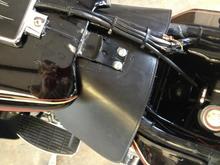 This is how I installed a Capt Itch on my '90, punched two holes to fit two each 1/4" lockwashers as spacers, which is a not as thick as the leather, so it compresses some to hold the leather snug but still tightens down solid.