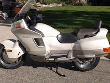 I have a Honda Pacific Coast. I've never even considered trying to run a car tire on it. there's not that much room under there and bike tires are not too expensive (if you run 140 -90-15 instead).