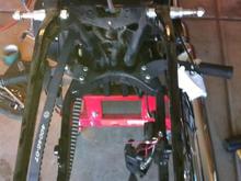 Rear fender off. Wiring conduit is draped over the socket set. I used a heat gun and gently pulled and it came right off.