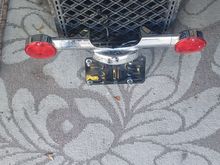 Rear turn signal bar/ license plate bracket. wires to LP light is cut.$ 20