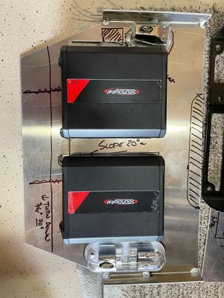 The general layout of the amps and power distribution blocks.  I am going to bend a flange down on front side, and the DSP will mount to an auxilliary plate screwed onto it.  Based on mocking it up, it should fit nicely.