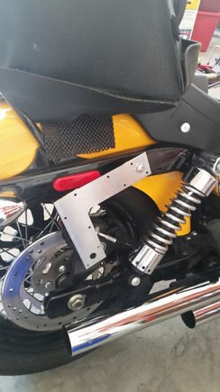 Mounted with a longer bolt and a small spacer to bring it out from the strut.