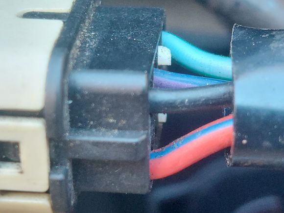 This is how the while plug is wired.  It is very easy to see which connections go where on the connector.  I am assuming the red/blue is power, black is ground....not sure of the teal and blue/purple wires. 