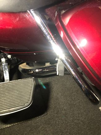 Zip tied to saddle bag crash bar.