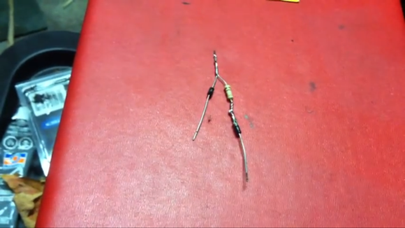 This shows a 560-ohm 1/2 watt resistor in line after the running light resistor