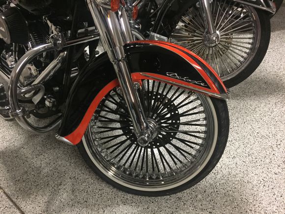 Front 21" chrome wheel with black spokes (foreground).  Front 21" chrome with chrome spokes (background).