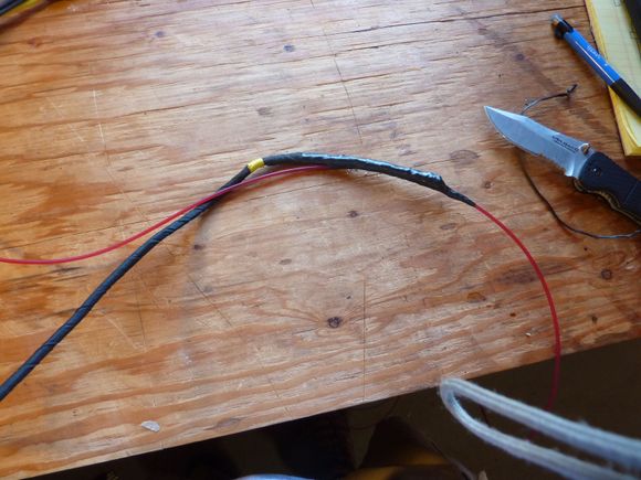 I used weed whacker line.  It's stiff but flexible.  I taped the wires in the middle of the weed whacker line so that I could push and pull on the line both ways if something got hung up in the bars.